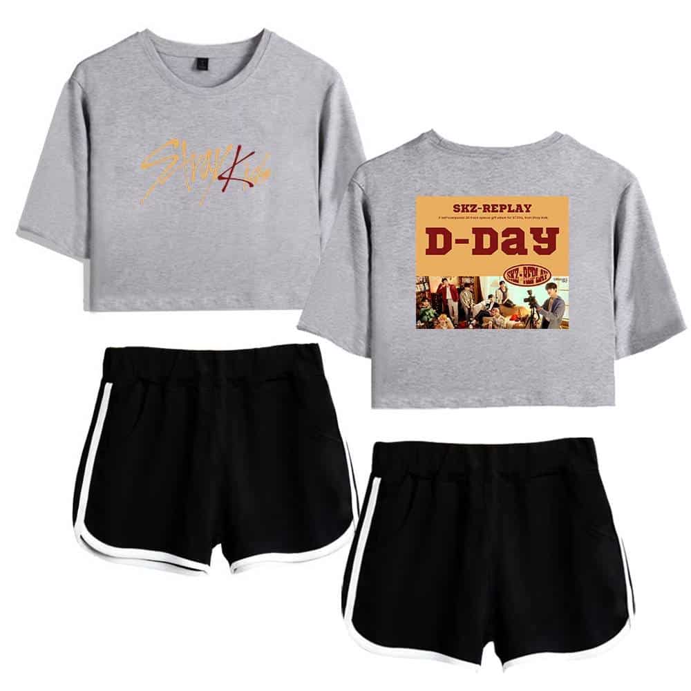 Stylish K-pop merch set featuring cropped gray T-shirts with bold graphics and black shorts with white trim, perfect for fans.