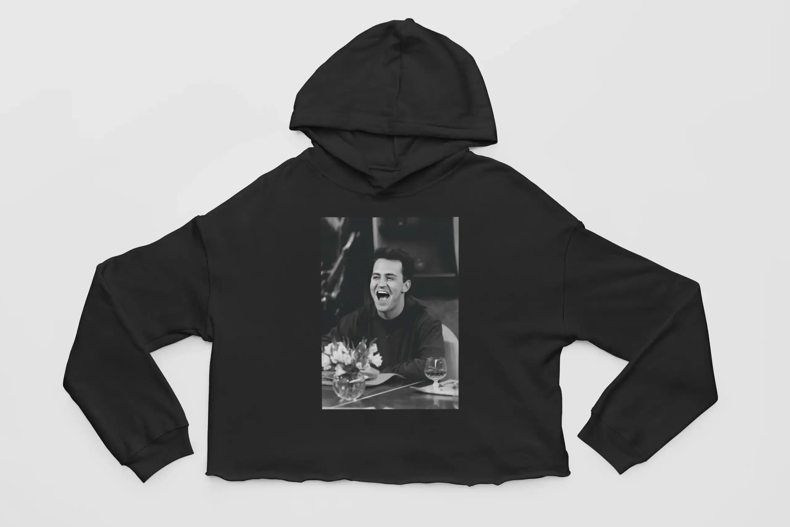Black hoodie with a printed photo of a smiling woman at a table, perfect for kpop merch fans.