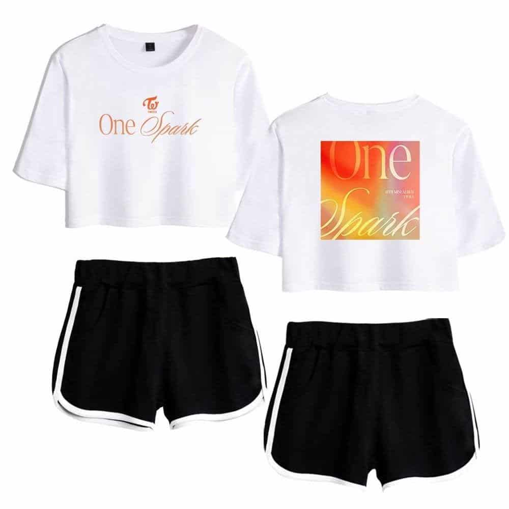 Graphic of two white cropped T-shirts with "One Spark" printed on front and back, paired with black athletic shorts with white side stripes.