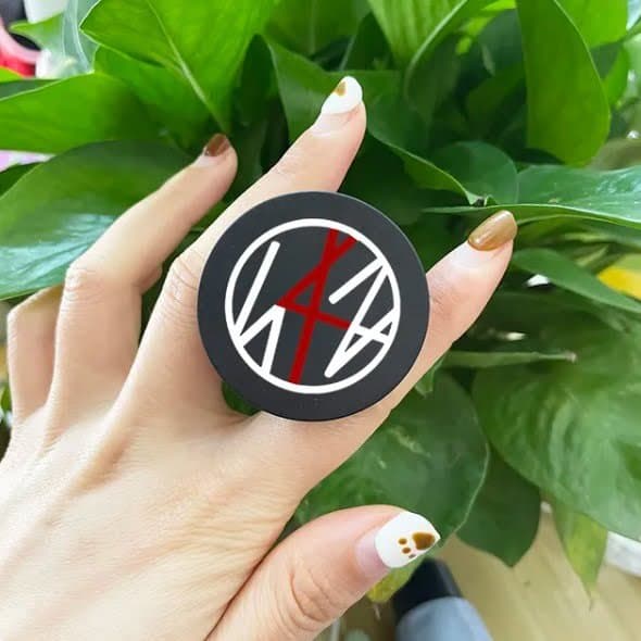 Kpop merch sticker featuring the BTS logo and design elements in black, white, and red.